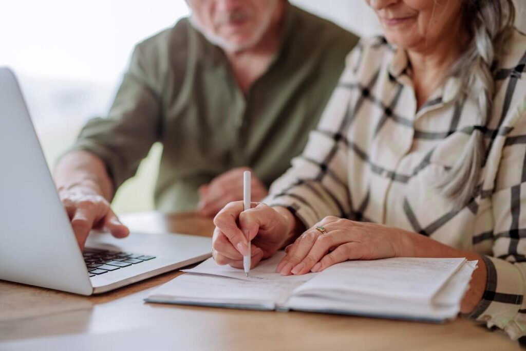 Older adults using laptop for financial planning for senior living