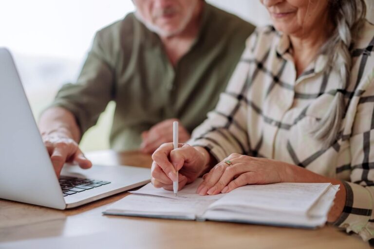 Older adults using laptop for financial planning for senior living