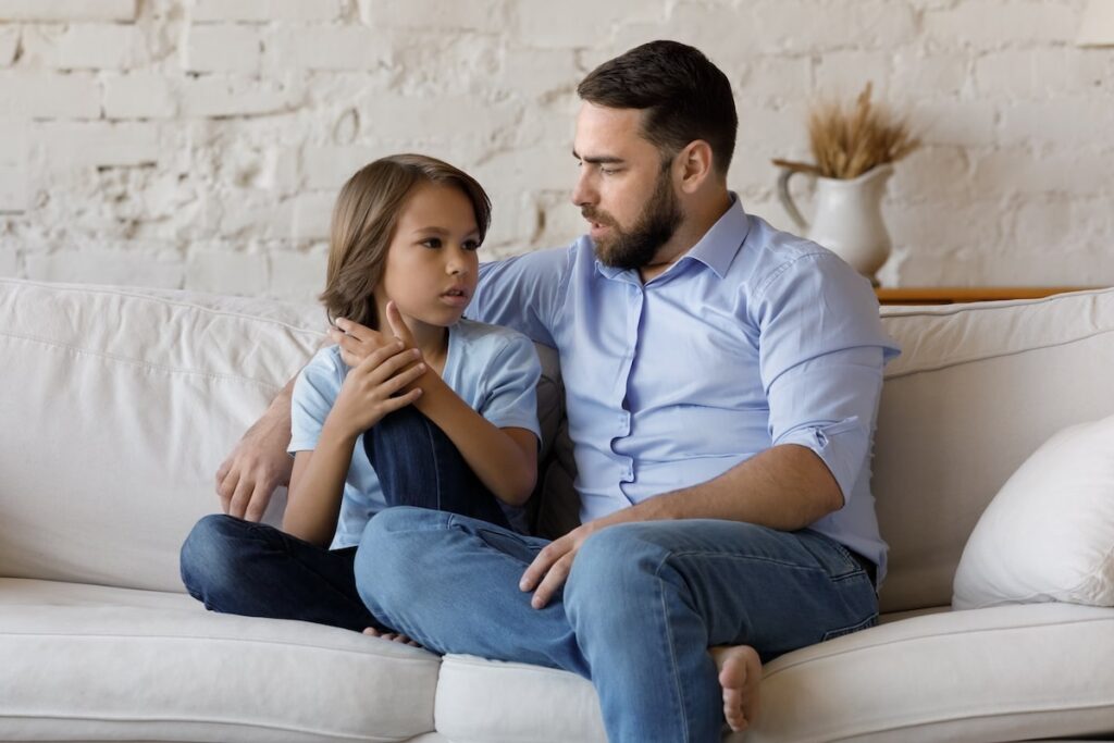 Adult man explaining to his son about grandpa's dementia
